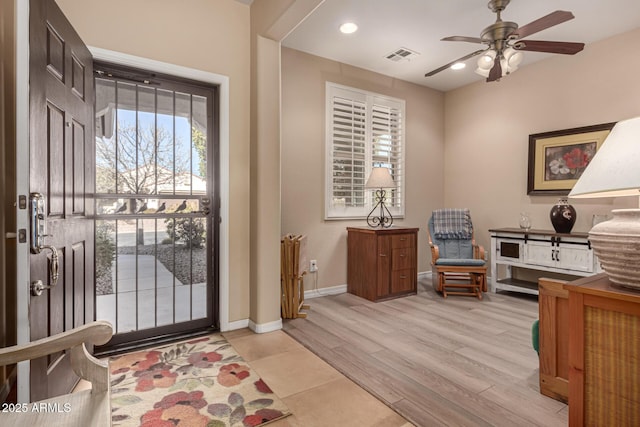 entryway with ceiling fan and light hardwood / wood-style floors