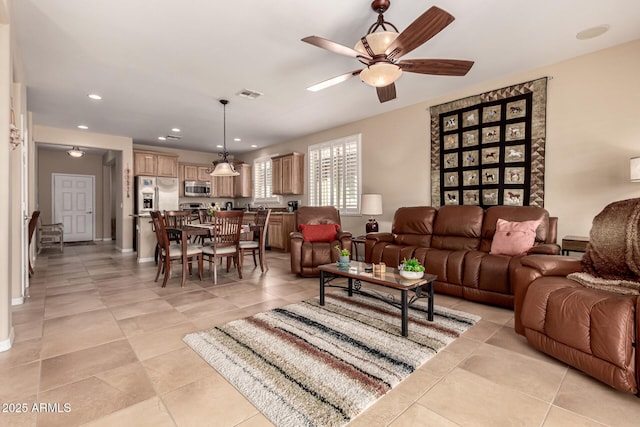 living room with light tile patterned flooring and ceiling fan