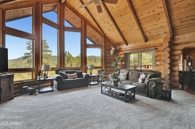 living room featuring beamed ceiling, wood ceiling, a healthy amount of sunlight, and high vaulted ceiling