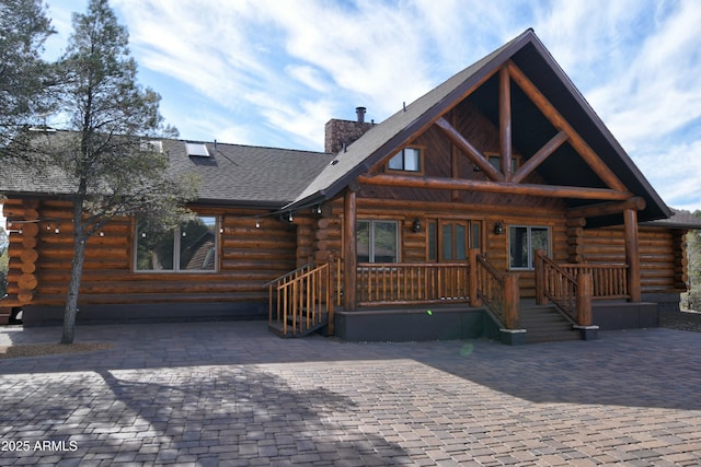 log cabin with a porch