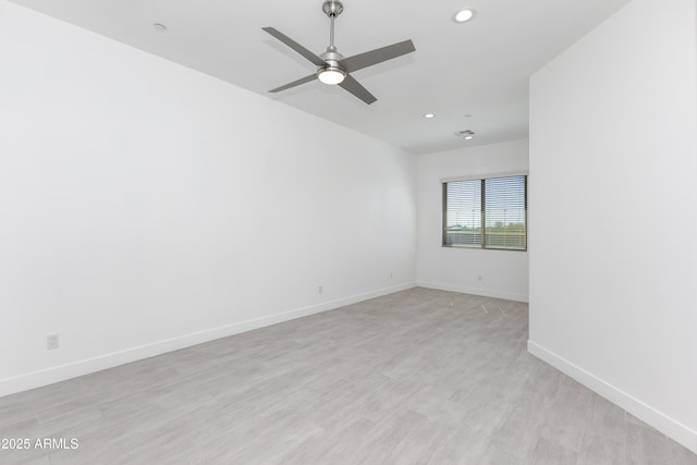 spare room with ceiling fan, recessed lighting, light wood-type flooring, and baseboards