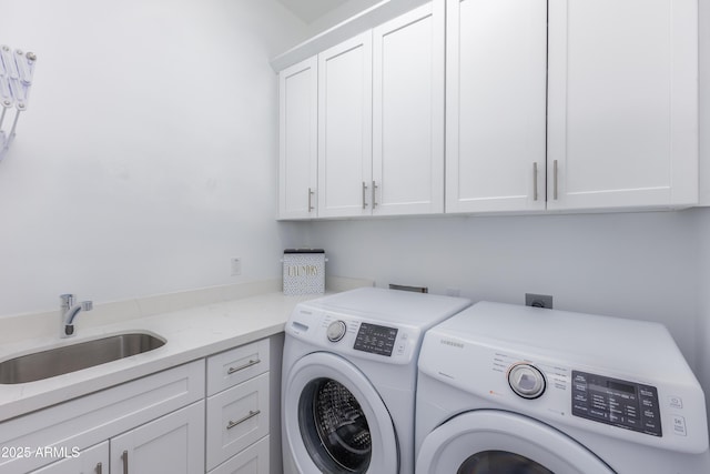 clothes washing area featuring independent washer and dryer, a sink, and cabinet space