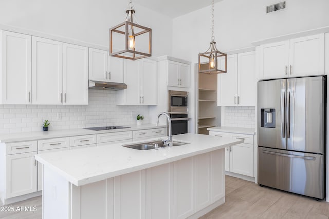 kitchen with visible vents, white cabinets, stainless steel appliances, under cabinet range hood, and a sink