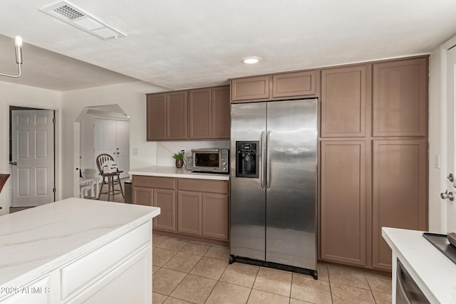 9825 N 44th Ave, Glendale, AZ 85302 - kitchen with appliances with stainless steel finishes, arched walkways, light tile patterned flooring, and recessed lighting