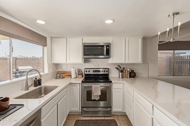9825 N 44th Ave, Glendale, AZ 85302 - kitchen featuring appliances with stainless steel finishes, white cabinetry, recessed lighting, light stone counters, and light tile patterned flooring