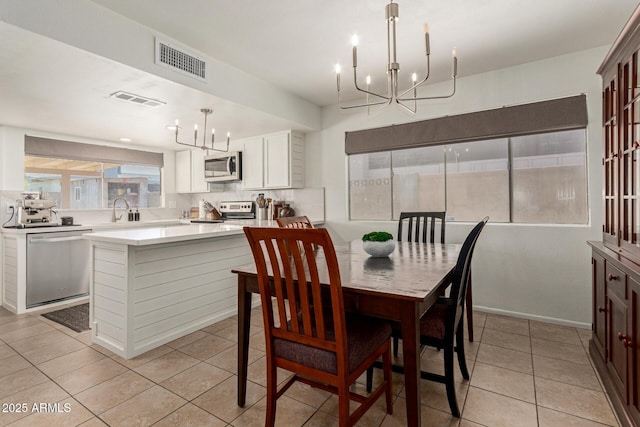 9825 N 44th Ave, Glendale, AZ 85302 - dining area featuring a chandelier and light tile patterned floors