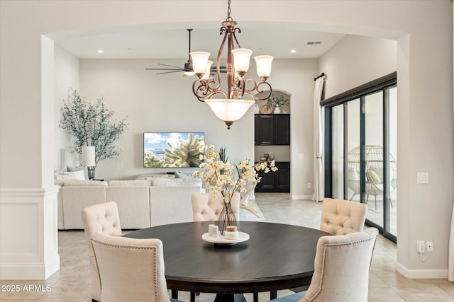 dining area featuring visible vents, light tile patterned floors, ceiling fan with notable chandelier, recessed lighting, and a decorative wall