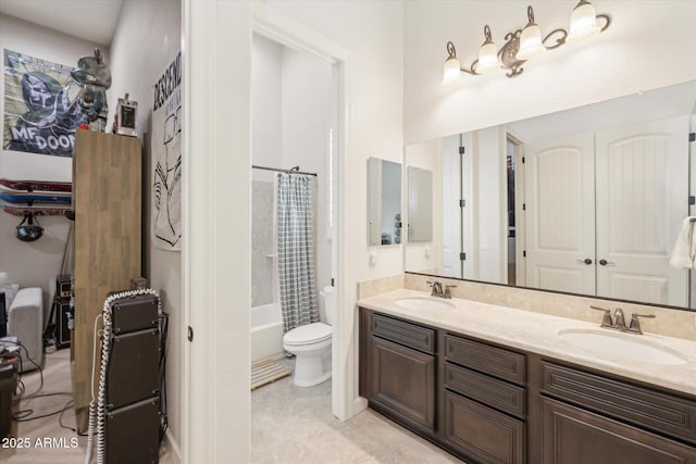 full bath with double vanity, tile patterned flooring, toilet, and a sink