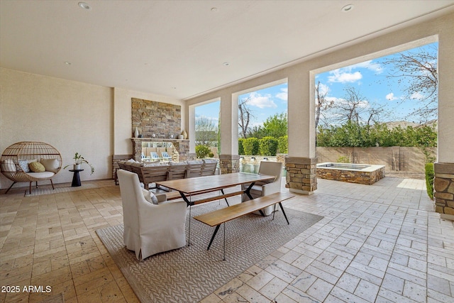 view of patio featuring outdoor dining space and fence