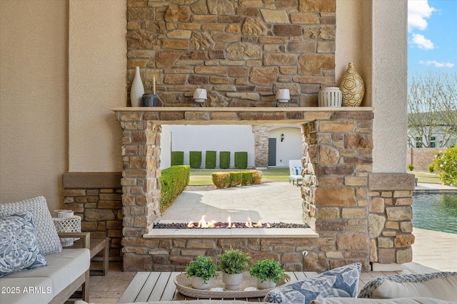 exterior details featuring arched walkways, stone siding, and stucco siding