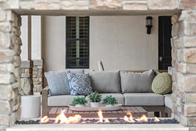 view of patio featuring an outdoor living space with a fire pit