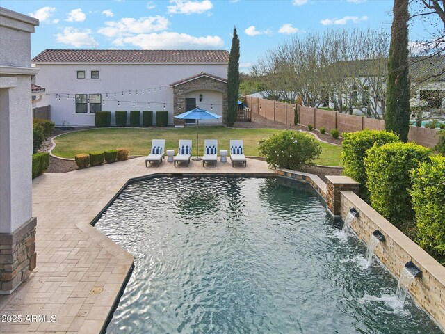 view of swimming pool featuring a patio, a lawn, and fence private yard