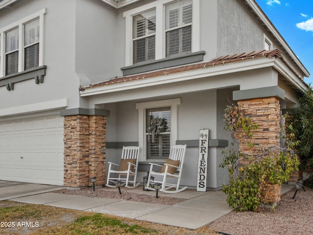 property entrance with a garage and covered porch