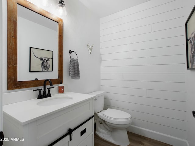 bathroom with vanity, hardwood / wood-style floors, and toilet