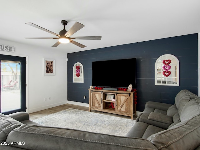 living room with ceiling fan and light hardwood / wood-style floors