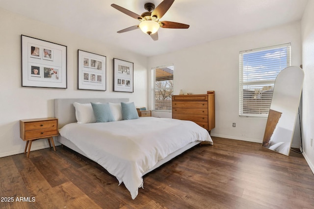 bedroom with dark wood-style floors, a ceiling fan, and baseboards