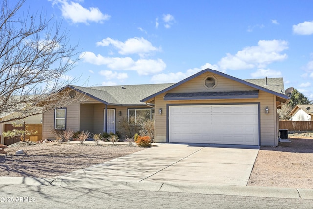 single story home featuring an attached garage, central air condition unit, a shingled roof, fence, and concrete driveway