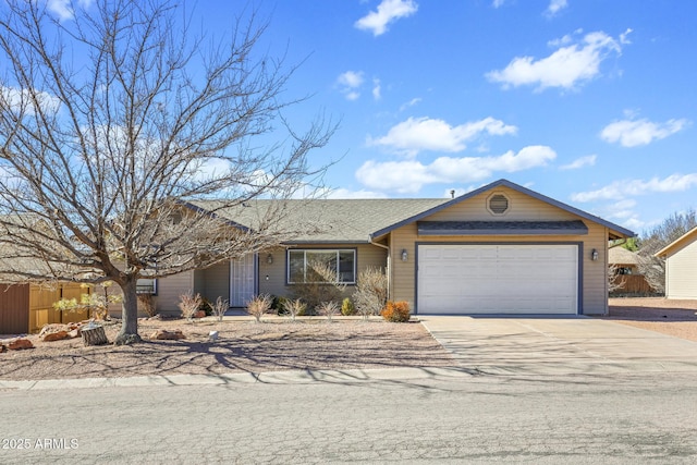 ranch-style house with driveway, an attached garage, and fence