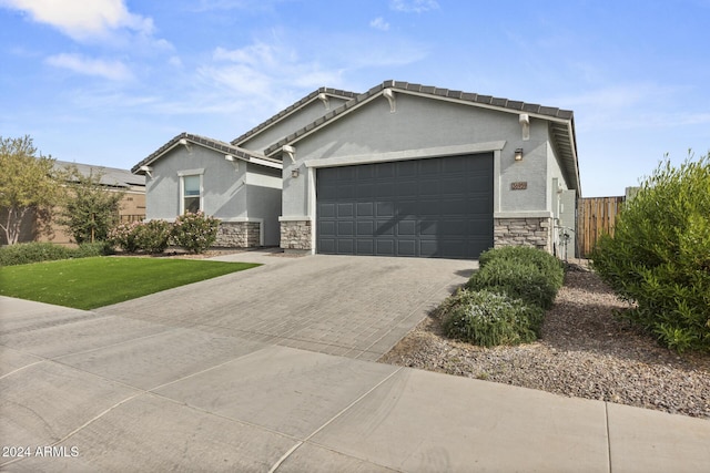 view of front of house featuring a garage and a front lawn