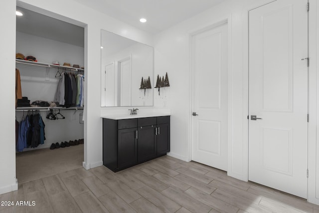 bathroom with hardwood / wood-style floors and vanity