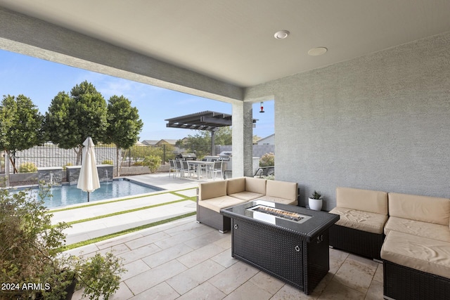 view of patio / terrace featuring a fenced in pool, pool water feature, and an outdoor living space with a fire pit