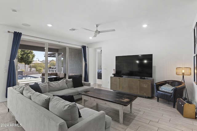 living room featuring ceiling fan and light wood-type flooring