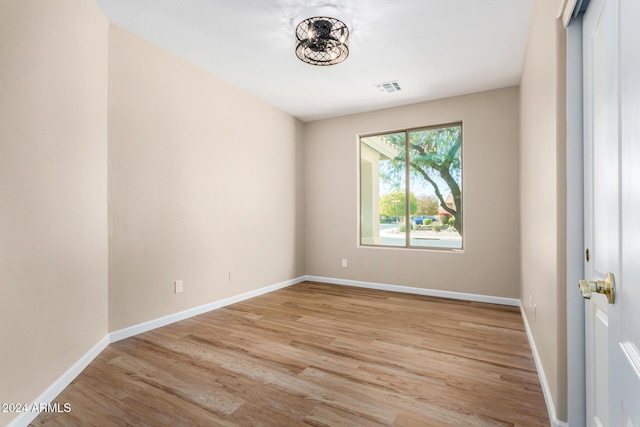 empty room with light hardwood / wood-style flooring