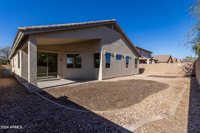 back of house with a patio and central AC unit