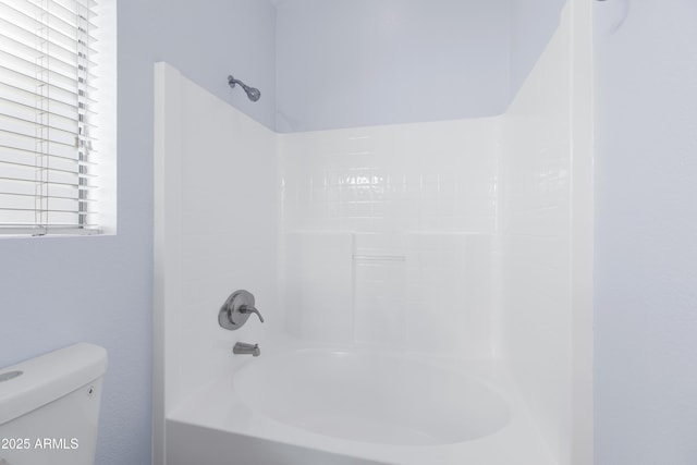 bathroom featuring toilet and shower / bathtub combination