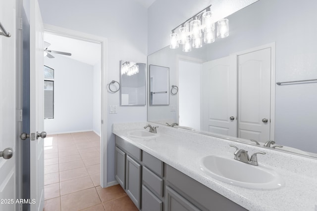 bathroom with ceiling fan, double vanity, tile patterned flooring, and a sink