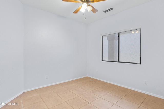 unfurnished room featuring baseboards, visible vents, a ceiling fan, and light tile patterned flooring