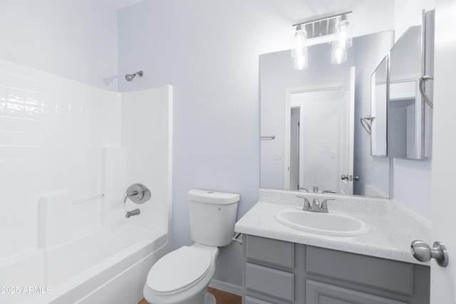 bathroom featuring  shower combination, vanity, and toilet