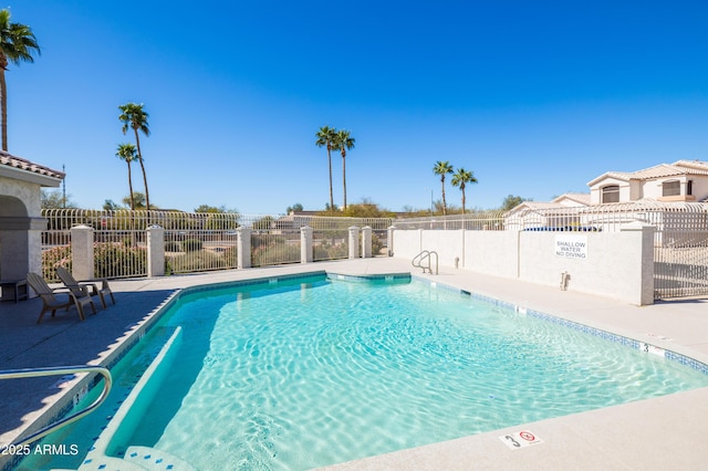 pool featuring fence and a patio