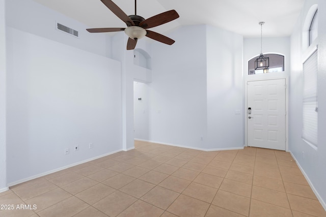 foyer with high vaulted ceiling, visible vents, baseboards, and a ceiling fan