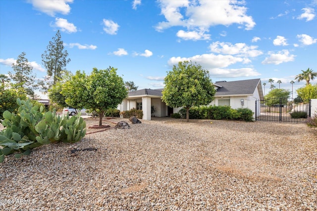 obstructed view of property with a gate and fence