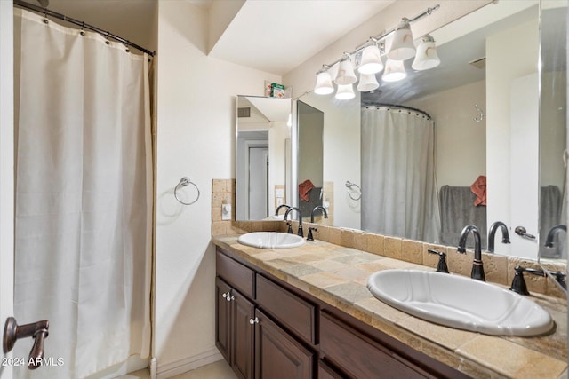 full bath featuring a sink and double vanity