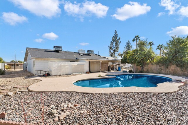 view of pool featuring a patio area, a fenced backyard, a fenced in pool, and cooling unit