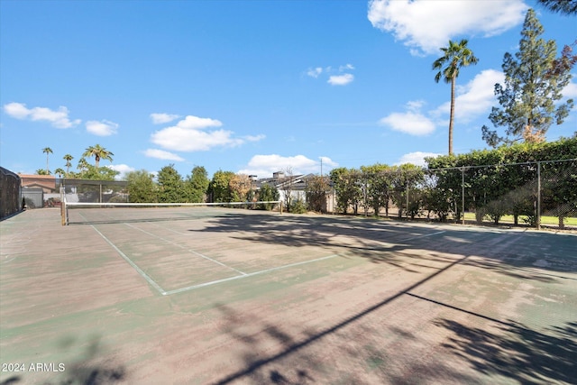 view of tennis court featuring fence