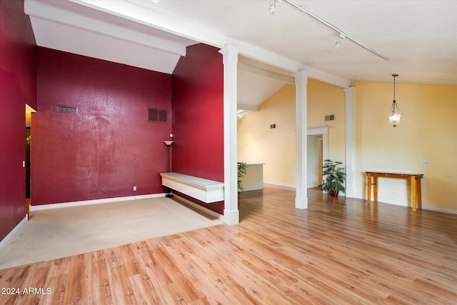 interior space with visible vents, decorative columns, and lofted ceiling with beams