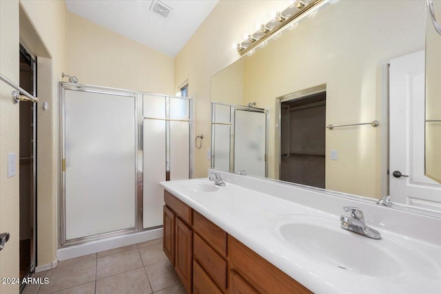 bathroom with tile patterned flooring, vanity, vaulted ceiling, and an enclosed shower