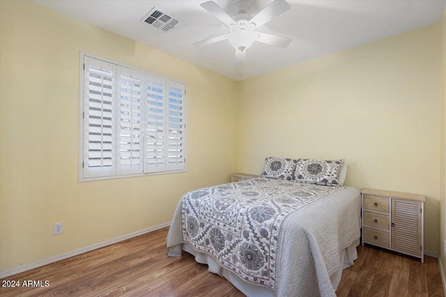 bedroom with ceiling fan and hardwood / wood-style floors