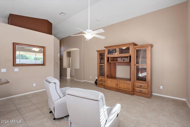 sitting room with vaulted ceiling, ceiling fan, and light tile patterned flooring