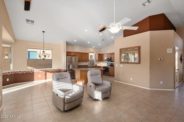 living room with light tile patterned floors, ceiling fan with notable chandelier, and high vaulted ceiling