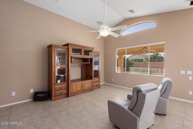 living area featuring vaulted ceiling, ceiling fan, and light tile patterned flooring