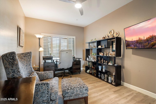 home office featuring a ceiling fan, baseboards, and wood finished floors