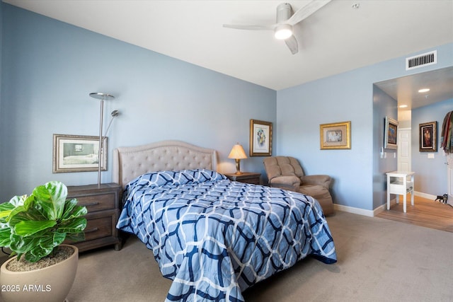 carpeted bedroom featuring visible vents, ceiling fan, and baseboards