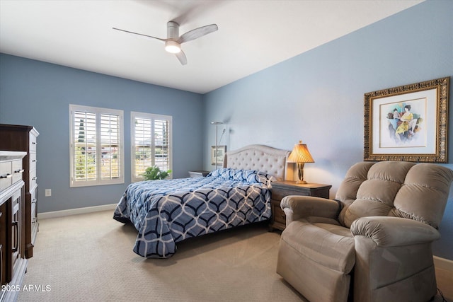 bedroom featuring light carpet, ceiling fan, and baseboards