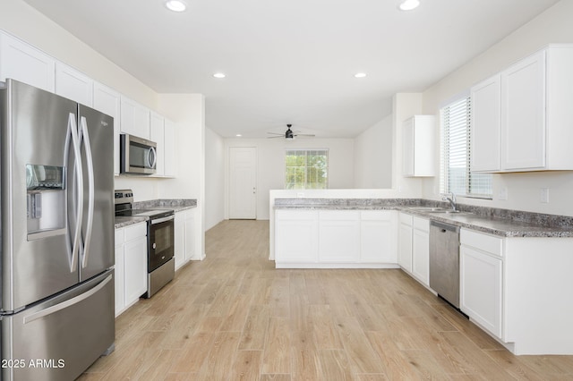 17864 W Paraiso Dr, Surprise, AZ 85387 - kitchen featuring ceiling fan, light wood-style flooring, white cabinets, recessed lighting, and stainless steel appliances