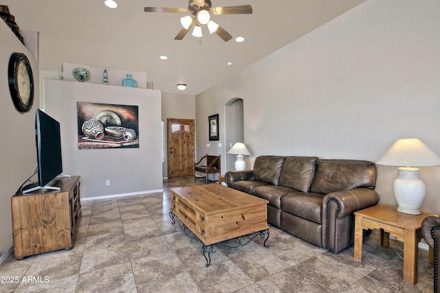 living area with recessed lighting, baseboards, arched walkways, and ceiling fan