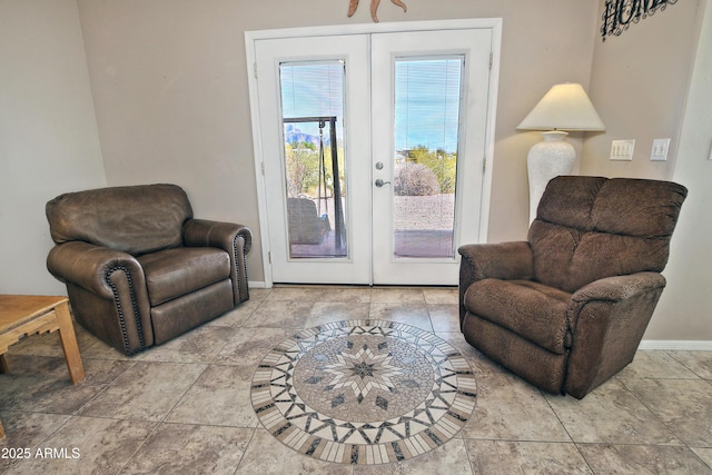 sitting room featuring french doors and baseboards